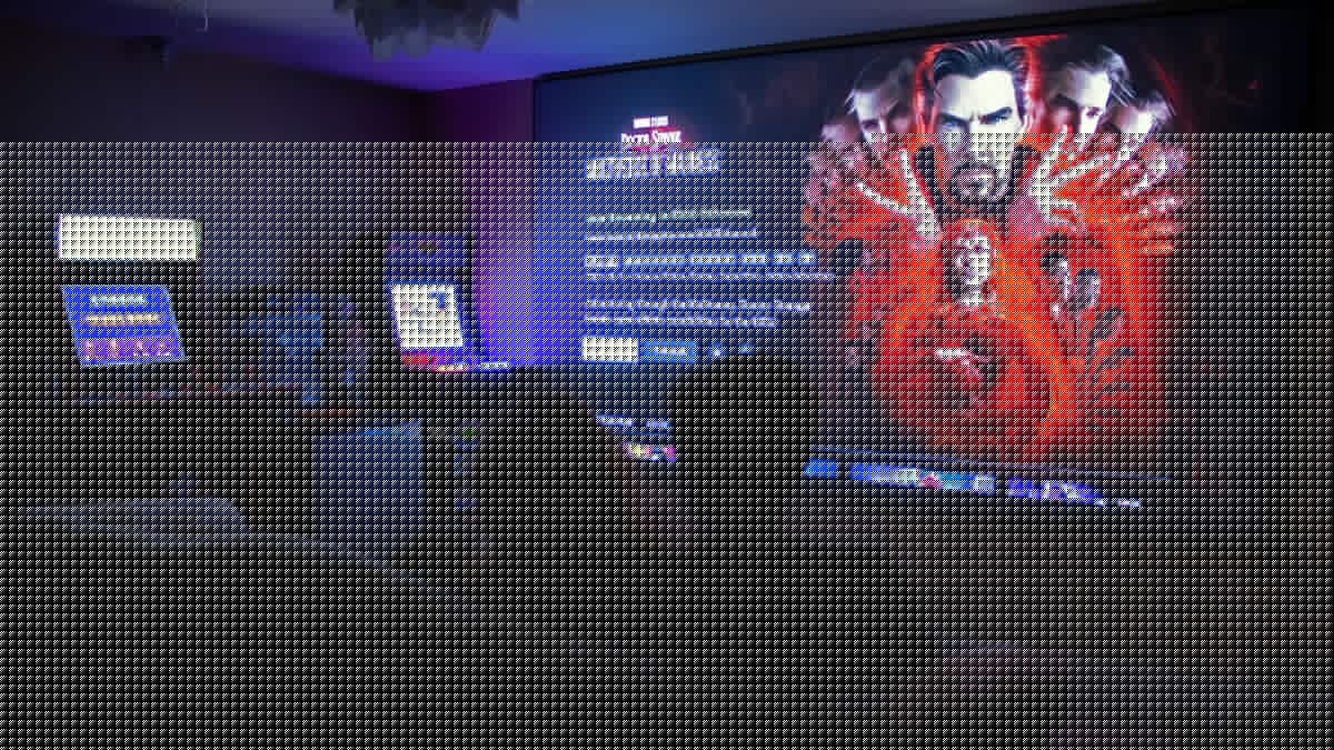 A couple watching a movie on a very large screen in a living room