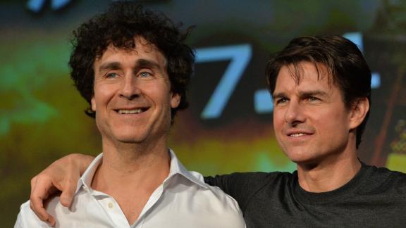 US actor Tom Cruise (C), accompanied by film director Doug Liman (L) and producer Erwin Stoff (R) pose at a press conference for their latest movie Edge of Tomorrow in Tokyo on June 27, 2014. The three are here to promote the science fiction film, adapted from the novel All You Need Is Kill written by Japanese novelist Hiroshi Sakurazaka.    AFP PHOTO / Yoshikazu TSUNO        (Photo credit should read YOSHIKAZU TSUNO/AFP via Getty Images)