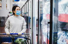 Asian female wearing a face mask shopping at the supermarket 